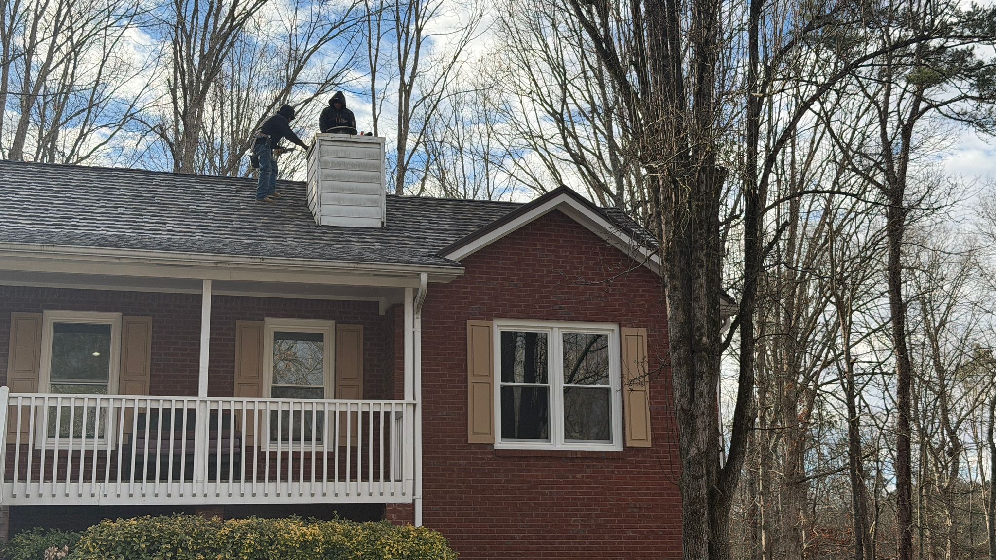 Chimney flashing repair to stop roof leak at masonry chimney penetration
